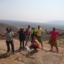 Some of the students and our guides on the Nejoio complex. Looking northeast, the large peralkaline Lutala complex (Sierra de Neve) can be seen in the background